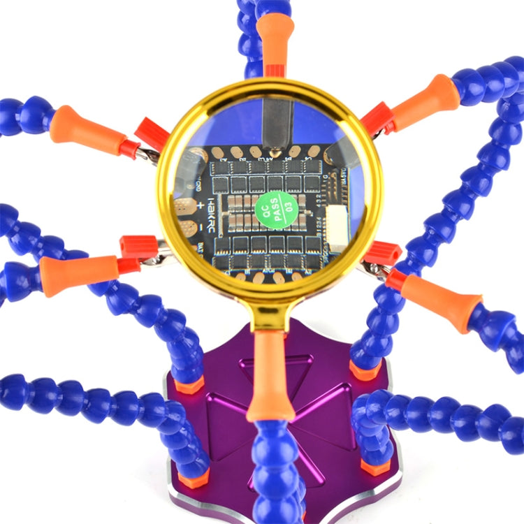 Welding power distribution board with gold-magnified PCB and blue clamp rods with orange tips