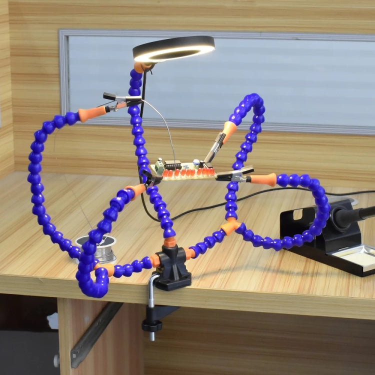 Desktop soldering lamp setup with blue flexible arms and ring light over work area