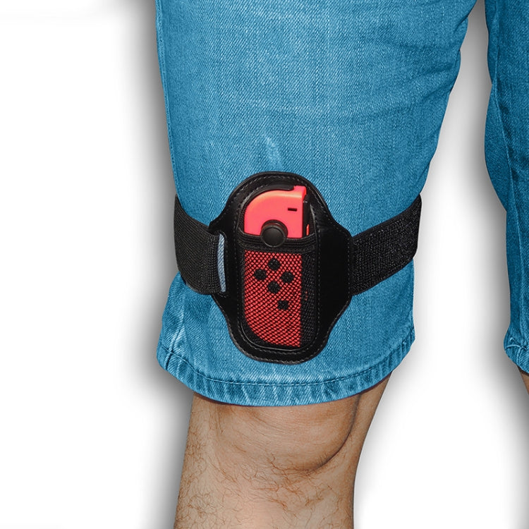 Black leg strap worn on blue jeans with red Joy-Con holster panel