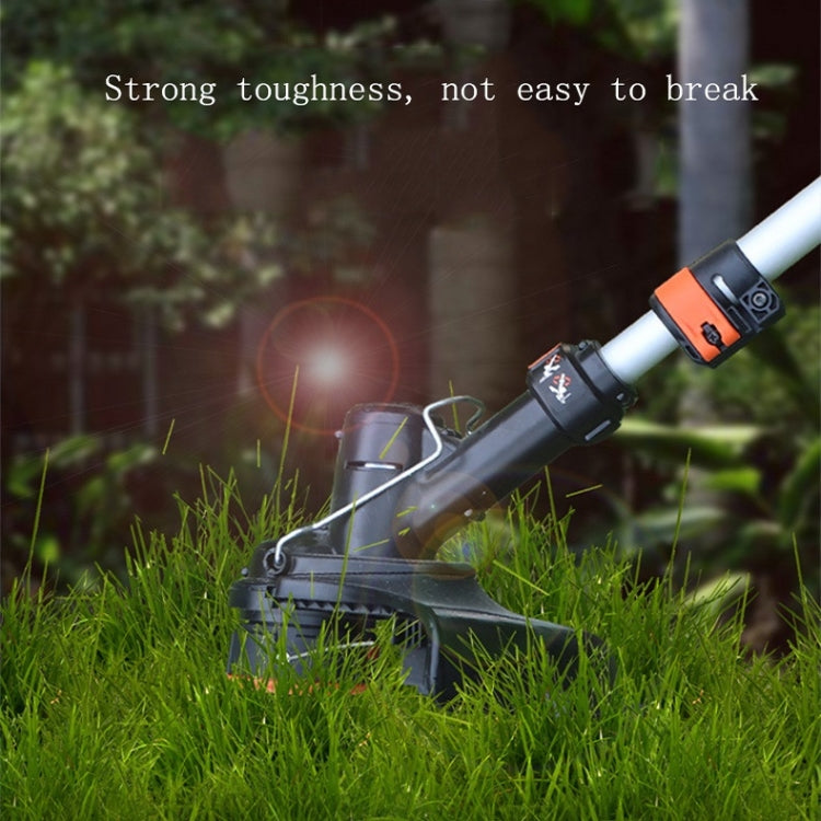 Grass trimmer cutting lawn with orange line spool cap visible