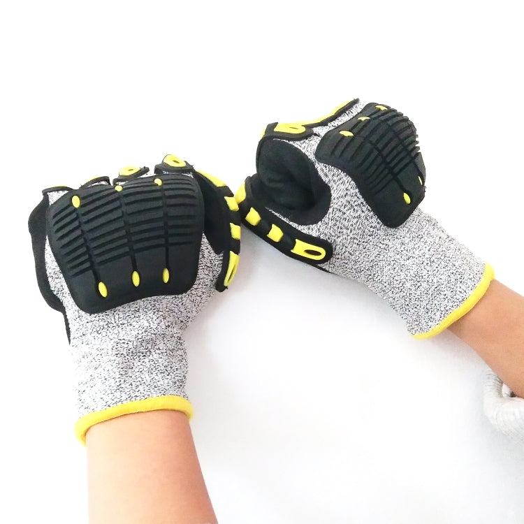 Person wearing cycling gloves with black knuckle pads, gray knit back, neon yellow wrist band