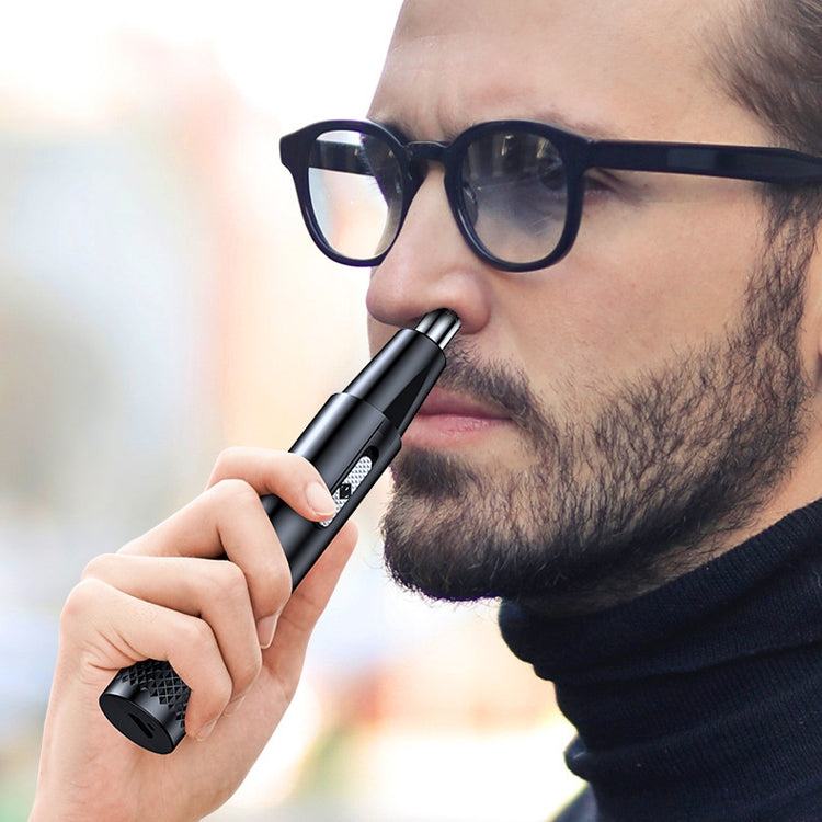 Man trimming nose hair with handheld electric nasal hair trimmer