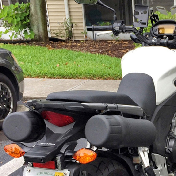 Pair of black motorcycle tool tubes mounted on the bike near the seat