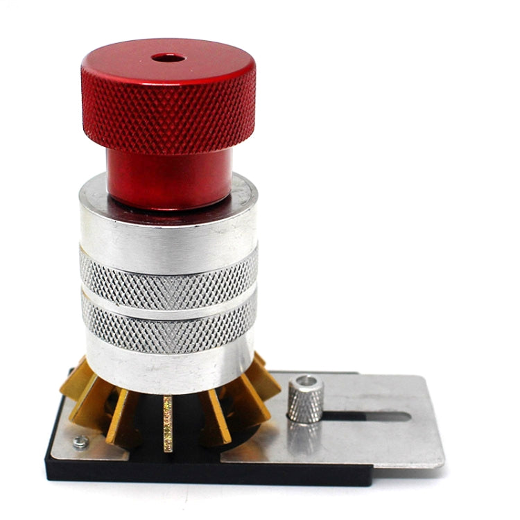 Watch bezel opener tool with red knob, silver grip, gold prongs on base plate