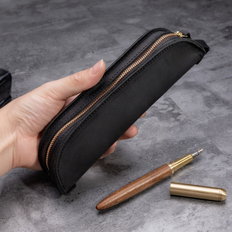 Black genuine leather zipper pencil case with gold-tone zipper trim, rectangular shape