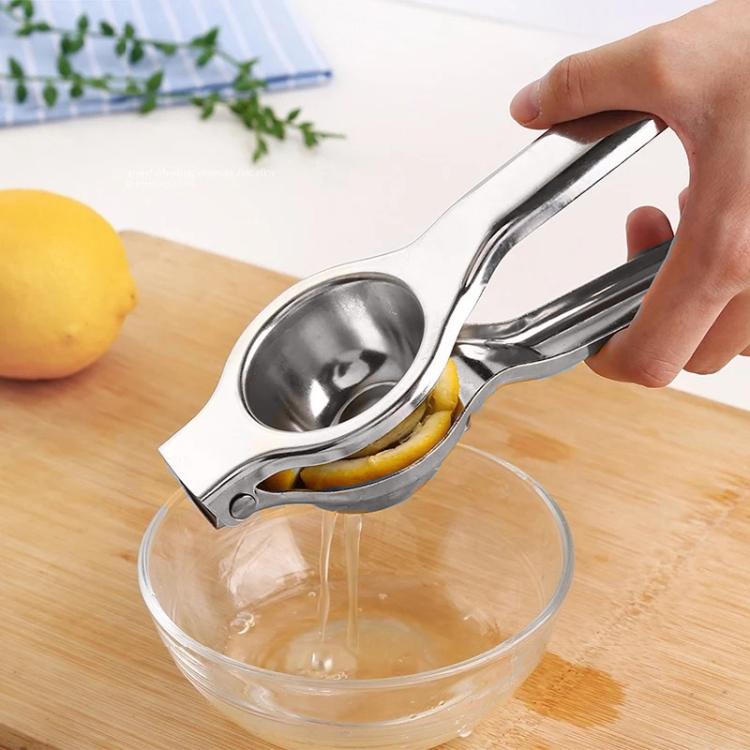 Manual lemon juicer pressing citrus over a bowl to extract juice