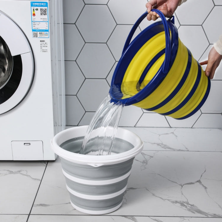 Blue folding silicone bucket with yellow interior pouring water into a gray basin