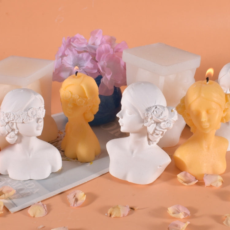Set of closed-eyes face candle busts with silicone mold pieces on a tray