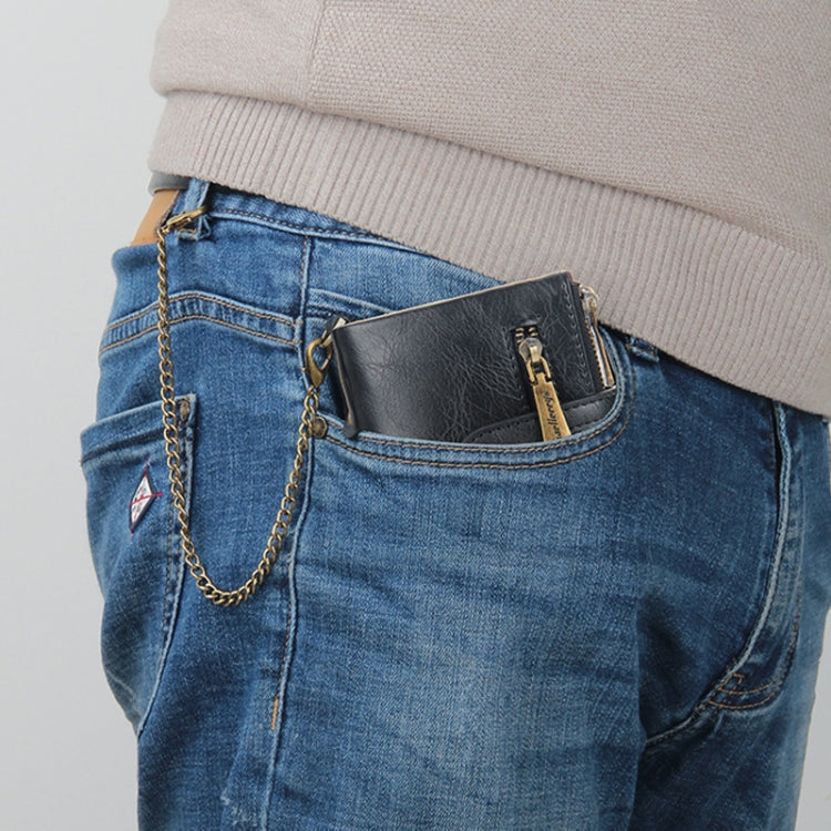 Black tri-fold zipper wallet clipped in jeans pocket with gold chain strap