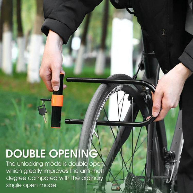 Bicycle U-lock secured to a wheel with orange handle and key inserted