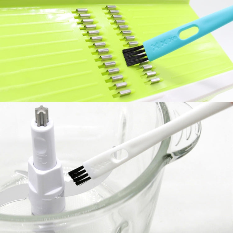 Double-ended cleaning brush scrubbing with a black bristle head near a machine opening