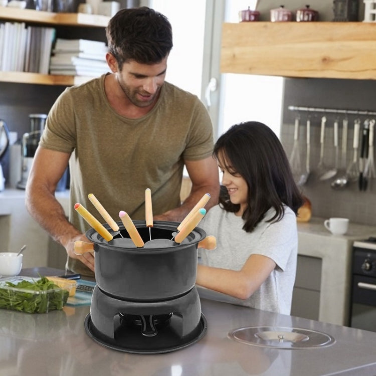 Ice cream fondue pot with wooden skewers in use at the table