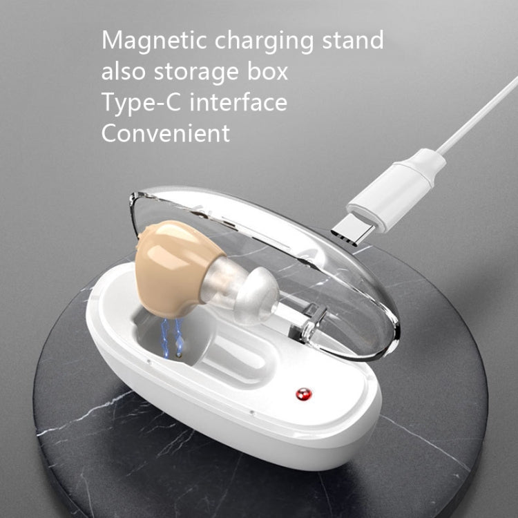 White magnetic charging stand with beige hearing aid and Type-C cable