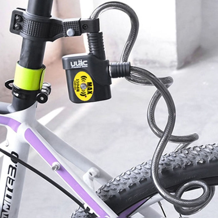 Bicycle cable alarm lock looped through bike frame and secured with alarm box