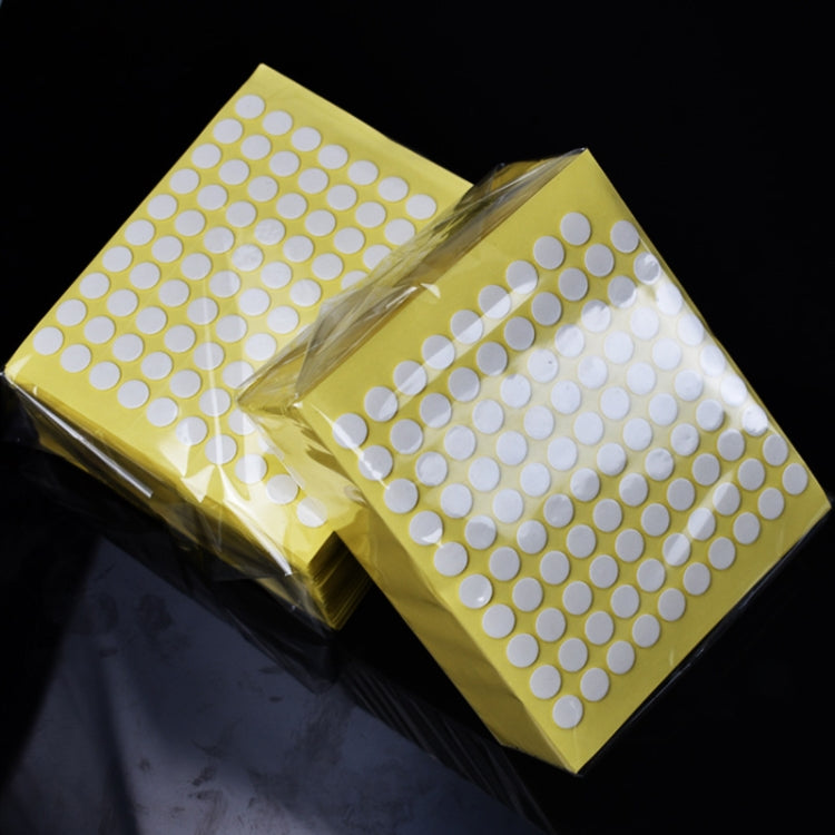 Transparent round double-sided adhesive tape dots in sealed yellow packaging