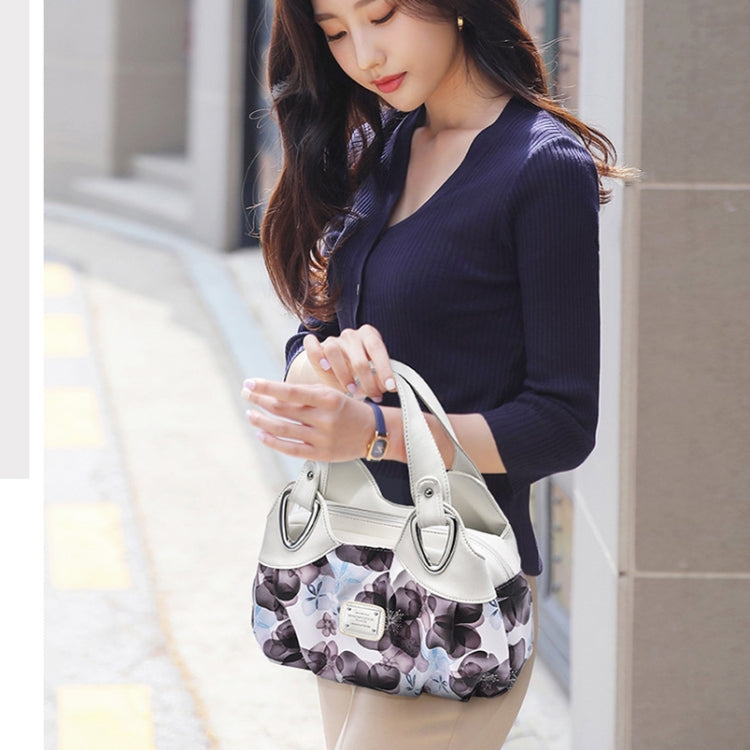 White soft leather handbag with curved handles and floral lining