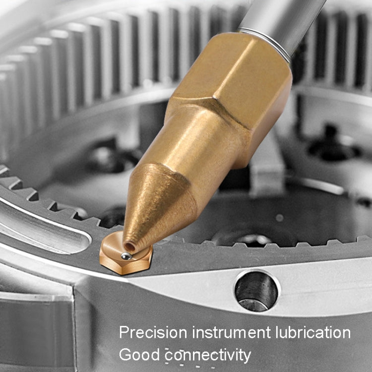 Grease nipple attached to a tool on a workshop surface for lubrication