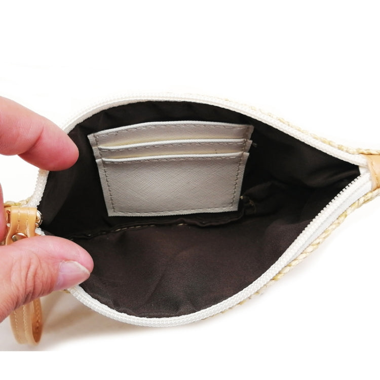 Open straw coin purse showing dark interior lining and stitched inner pocket.