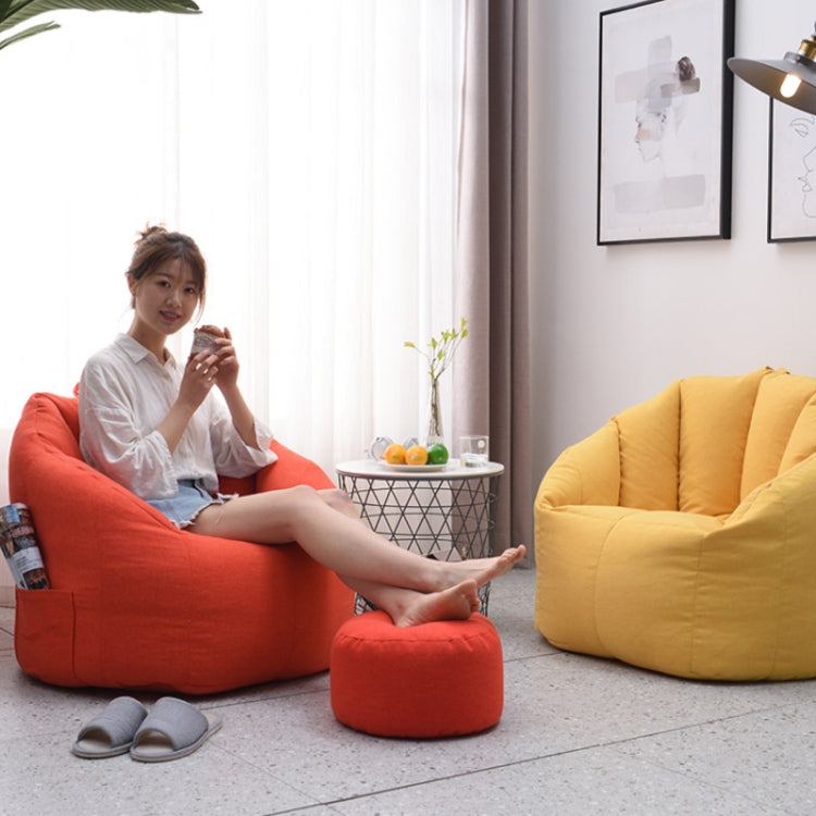 Lemon yellow lazy sofa beanbag chair cover with tufted back beside a red ottoman