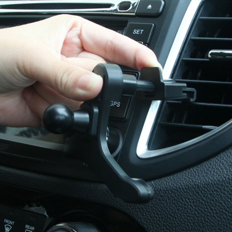 Hand mounting a black car air vent phone holder clip on the dashboard vent.