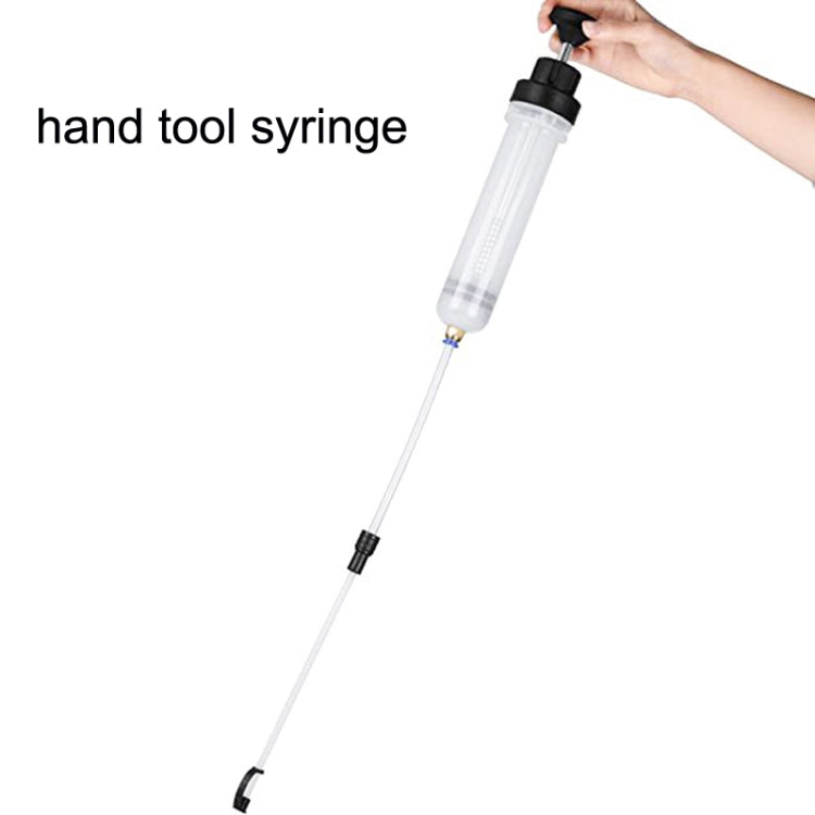 Brake fluid syringe pump held by hand with clear cylinder and long hose
