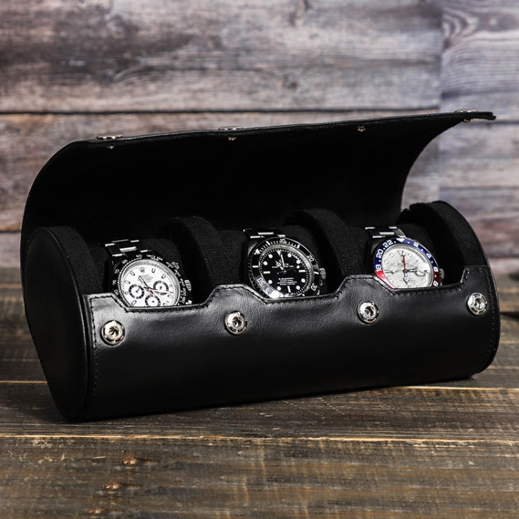 Black leather watch storage box holding four watches in padded slots