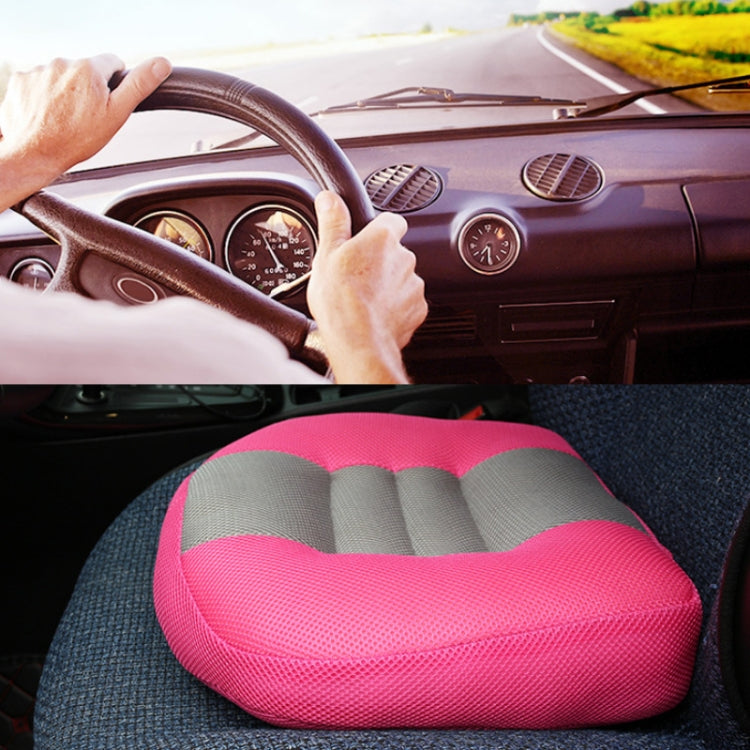 Pink thick hip cushion pad placed on a car seat, with gray contoured inserts.