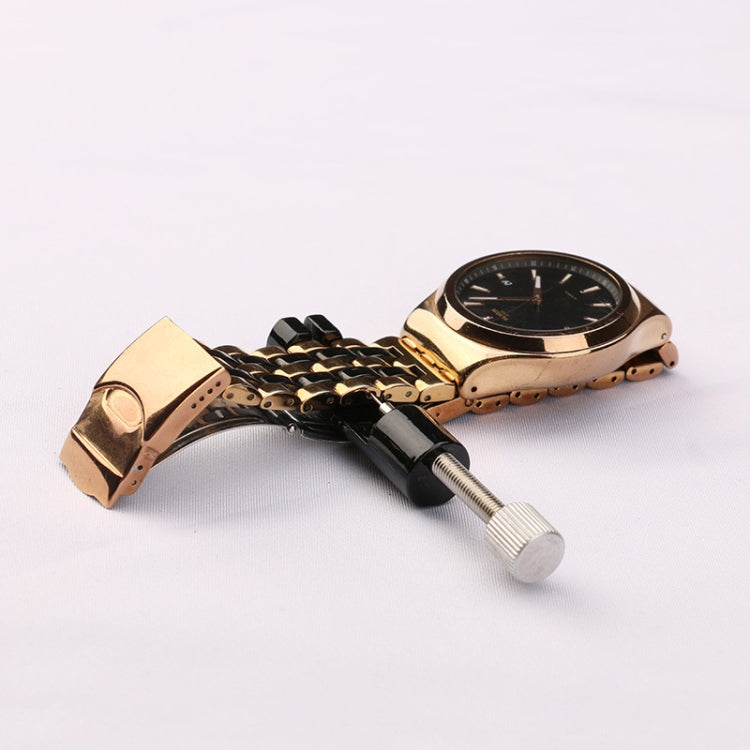 Golden watch strap and black link removal tool with handle and pin rod