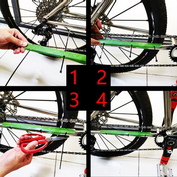 Green bike chain guard installed on a bicycle; hand adjusting near the chain.