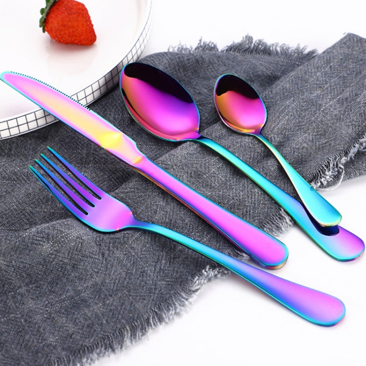 Rainbow stainless steel spoon and fork set on gray cloth, glossy iridescent finish
