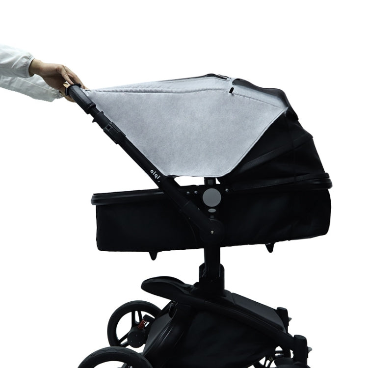 Gray stroller sunshade cover being secured to stroller with sunroof window