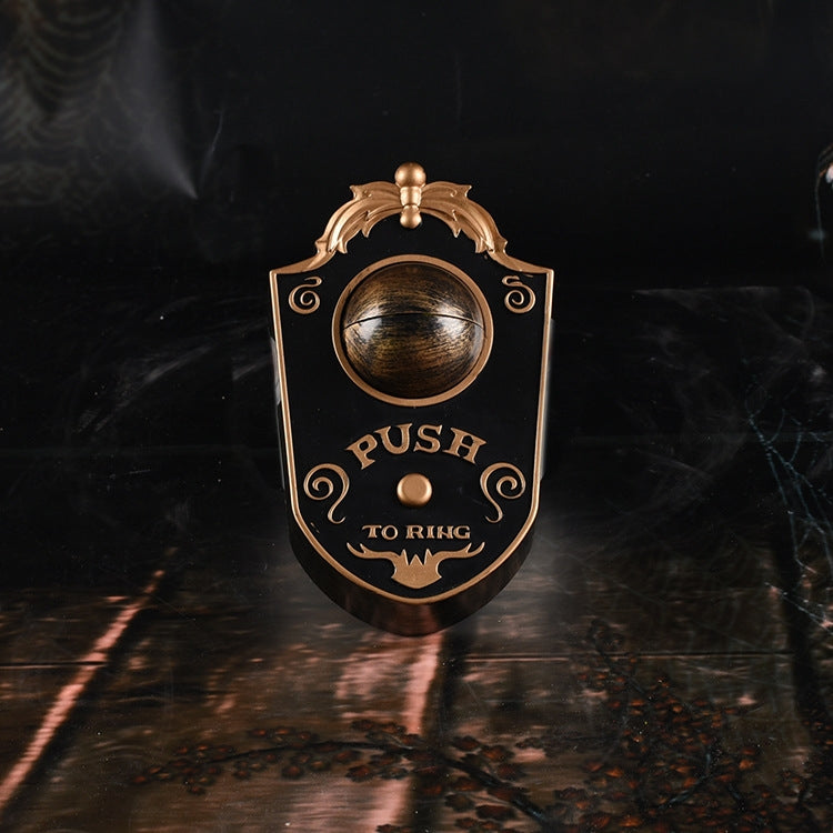 One-eyed horror doorbell pendant with black shield and brass frame