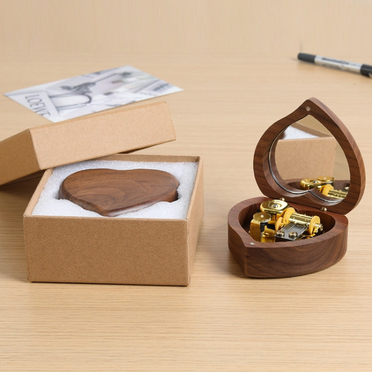 Heart-shaped wooden music box in open packaging with mirror lid and gold-tone mechanism