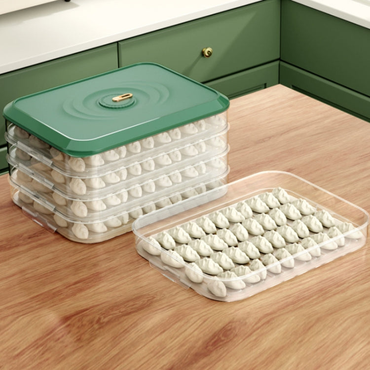 Green-lidded stackable dumpling storage box with white dumplings and separate tray.