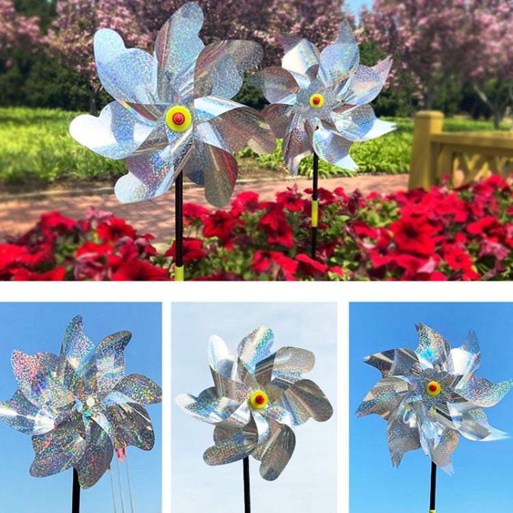 Three reflective windmill pinwheels on black stakes with blue-silver blades and yellow hubs