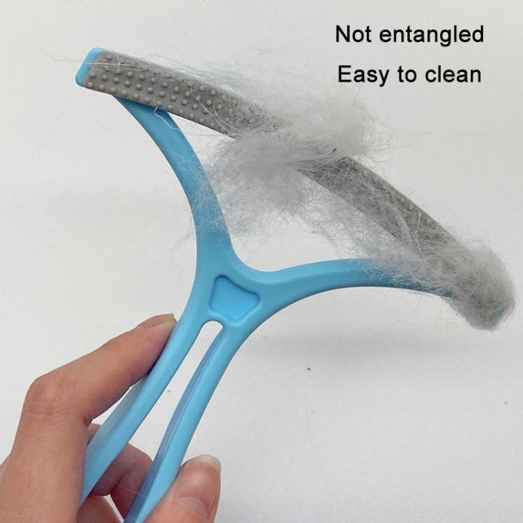 Blue pet fur scraper removing loose pet hair with gray textured head