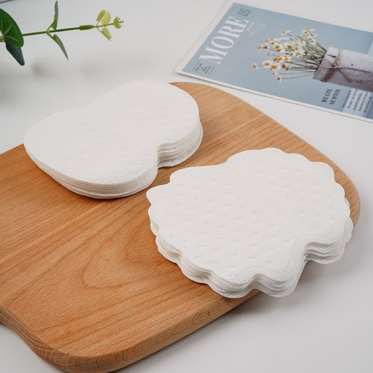 Stack of underarm sweat-absorbing stickers and separate pad, white, textured