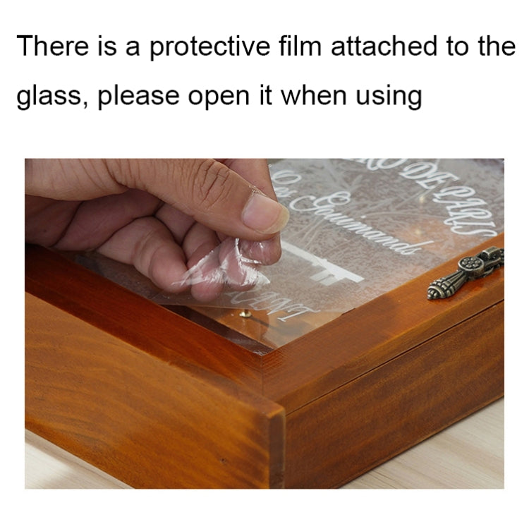 Hand opening the glass front of a wooden wall key storage box with key hooks