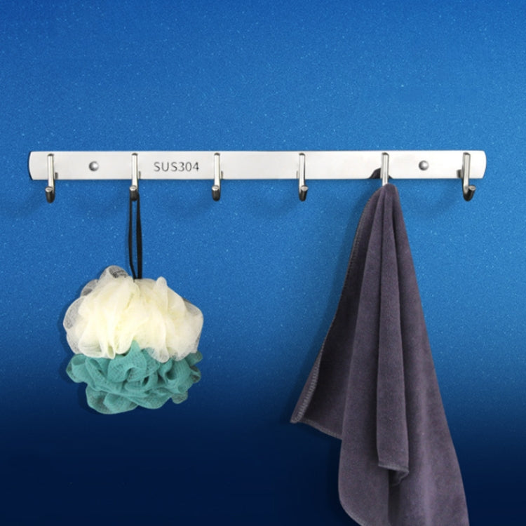 Stainless steel no-punch coat hook rail with three hooks, holding towels and a bath sponge