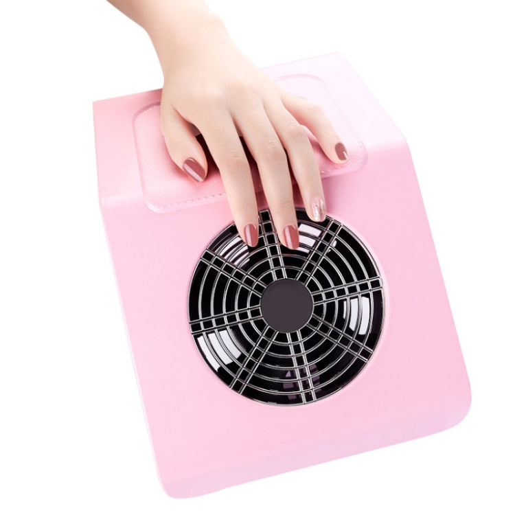 Pink nail dust vacuum cleaner with hand resting on the round suction vent