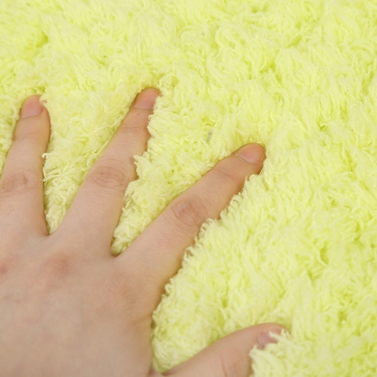 Lime green plush pet sleep pad texture with hand pressing the fabric