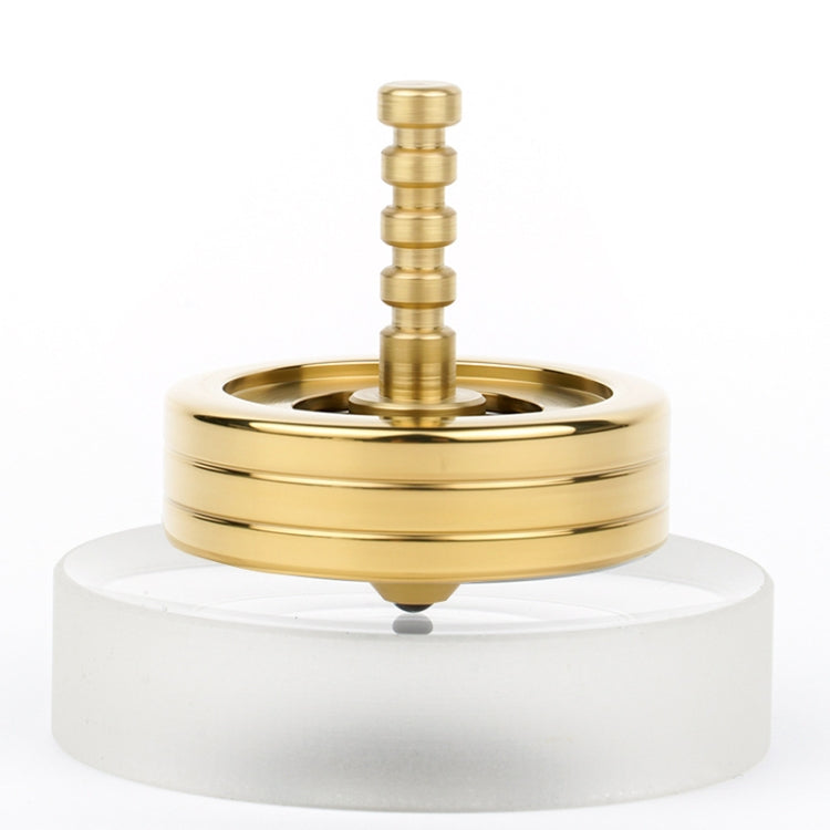 Brass-colored polished fidget spinner with stacked ring base and central post