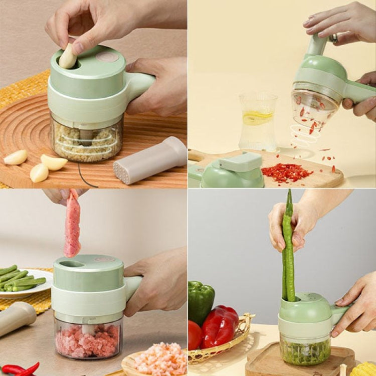 Green handheld electric garlic chopper set with clear bowl and multiple food-processing attachments