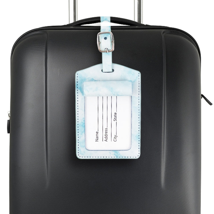 Blue marbled PU leather luggage tag with metal buckle attached to suitcase