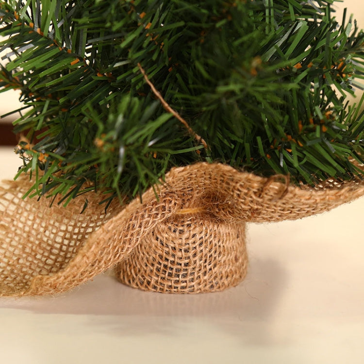 Close-up of mini Christmas tree burlap-wrapped base with green needle branches