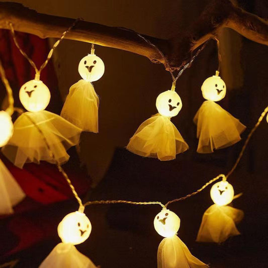 Warm white LED ghost string lights with tulle cloth ghost ornaments on a wire garland