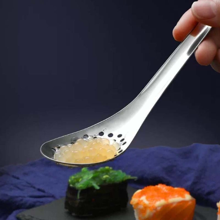 Stainless steel caviar colander spoon holding caviar beads in the perforated bowl
