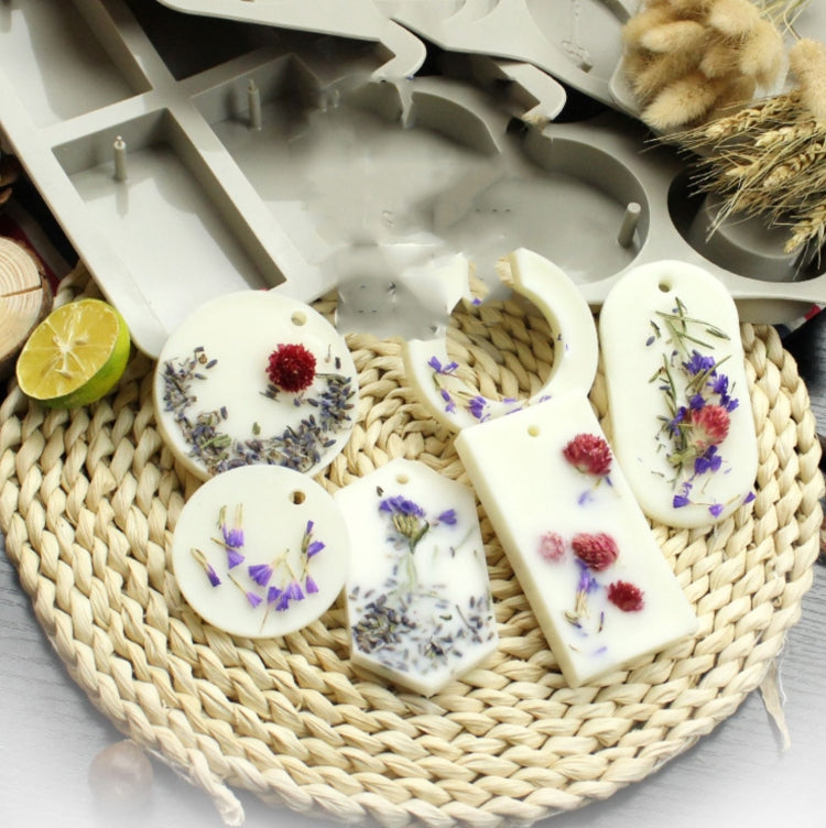 Flower-decorated soap pieces, round and rectangular, with dried lavender and red buds