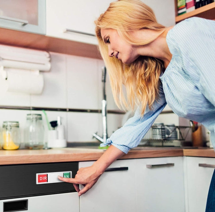 Woman placing a dishwasher status magnet on the dishwasher door