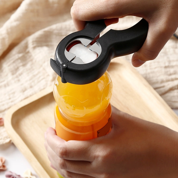 Bottle opener in use on plastic bottle, black tool with red ring